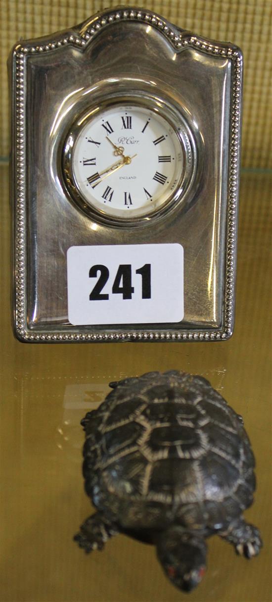 Silver tortoise and clock